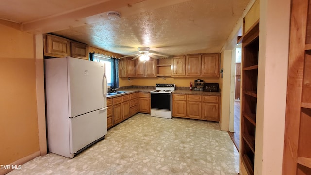 kitchen with ceiling fan, white appliances, sink, and a textured ceiling