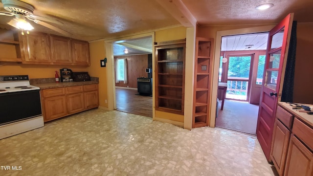 kitchen with ceiling fan, a textured ceiling, and white range with electric stovetop