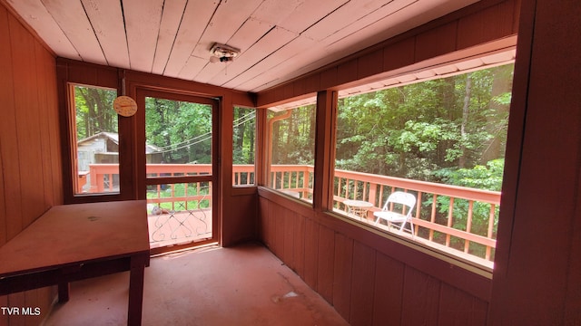 unfurnished sunroom with wooden ceiling