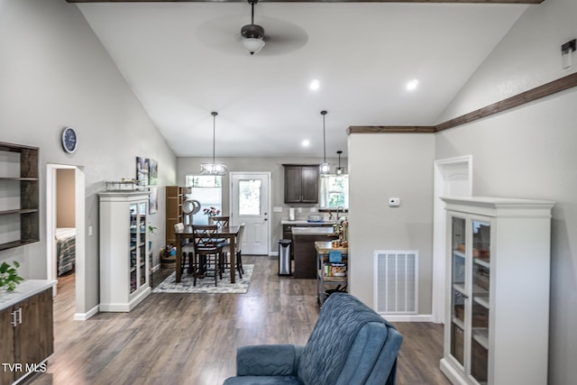 living room with ceiling fan, dark wood-type flooring, and high vaulted ceiling