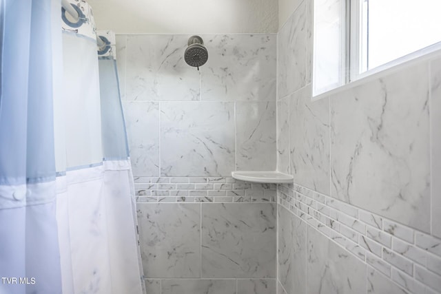 bathroom with a tile shower