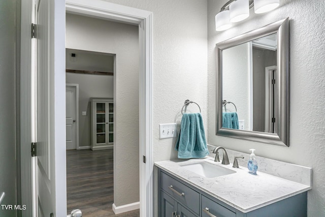 bathroom with hardwood / wood-style floors and vanity