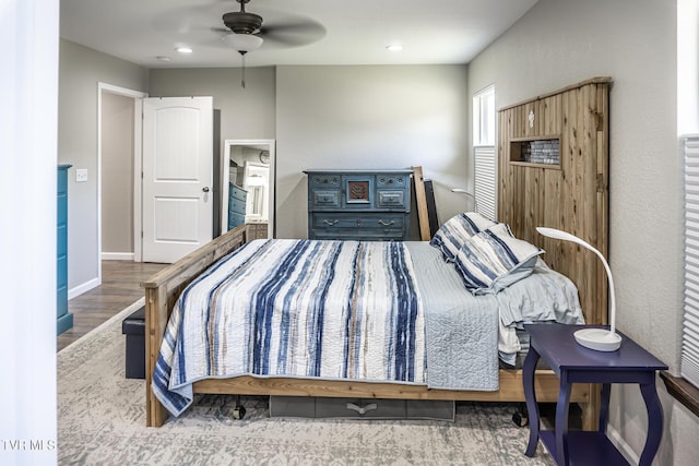 bedroom with hardwood / wood-style flooring and ceiling fan