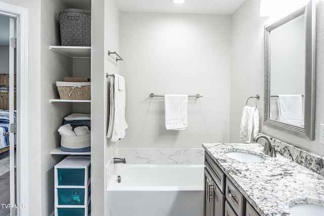 bathroom with a bathing tub and vanity