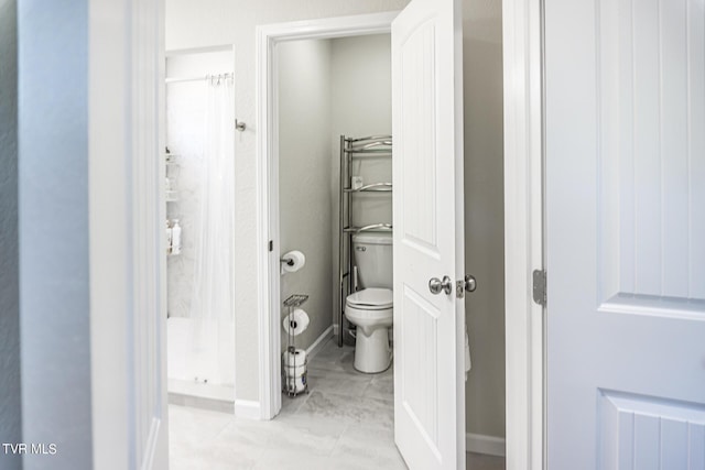 bathroom featuring toilet and a shower