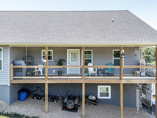 rear view of property featuring a deck