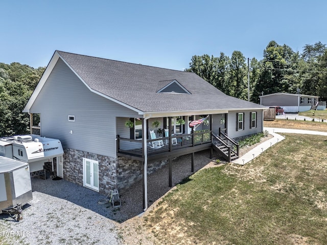 view of front of property with covered porch and a front yard