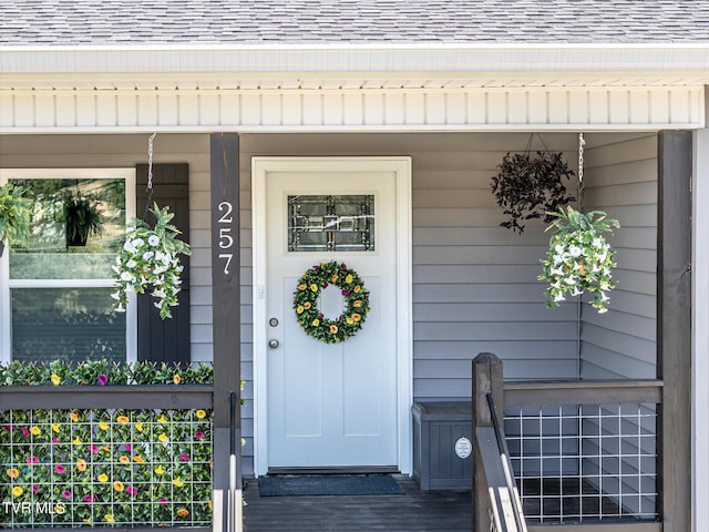 view of exterior entry with a porch