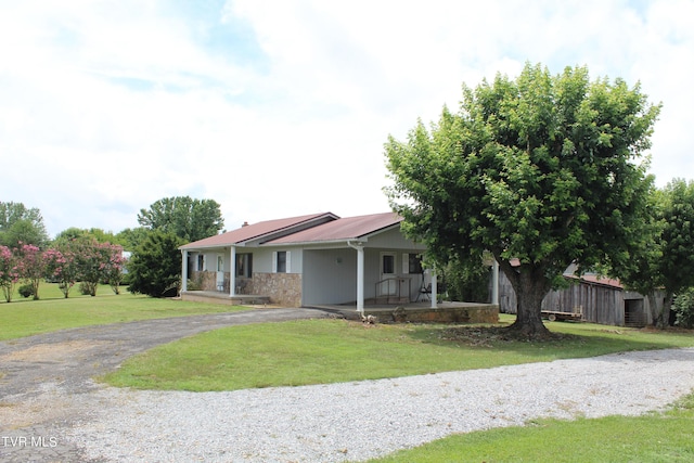 view of front of house with covered porch and a front yard