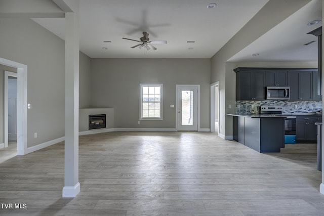 unfurnished living room with ceiling fan and light hardwood / wood-style flooring