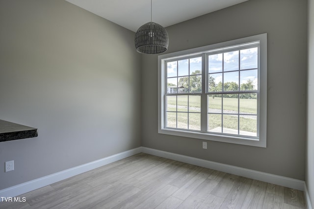 unfurnished dining area featuring light wood-type flooring