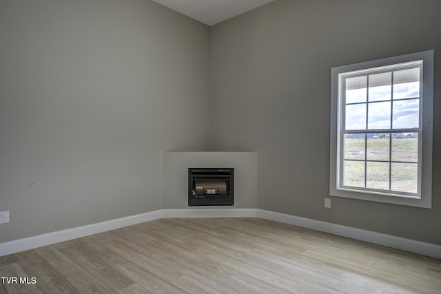 unfurnished living room with light wood-type flooring