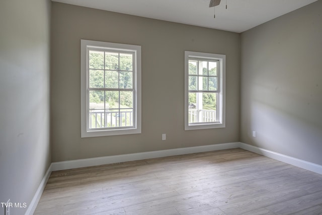 empty room featuring ceiling fan and light wood-type flooring