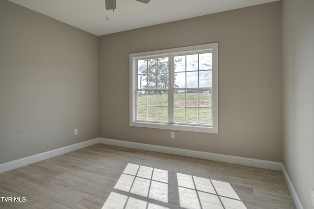 unfurnished room with light hardwood / wood-style flooring and ceiling fan