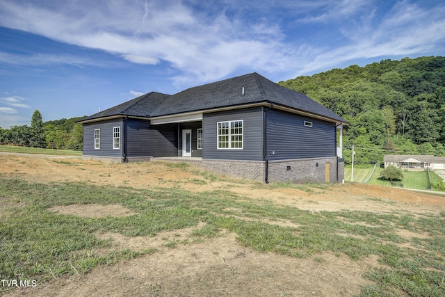 rear view of property featuring a lawn