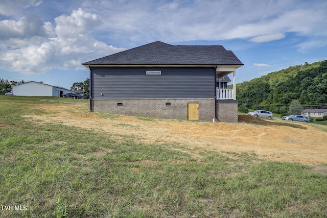 view of property exterior with a lawn and a balcony