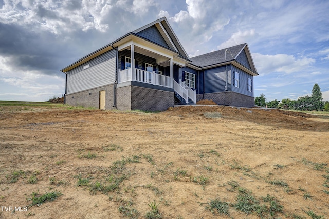 view of property exterior featuring covered porch