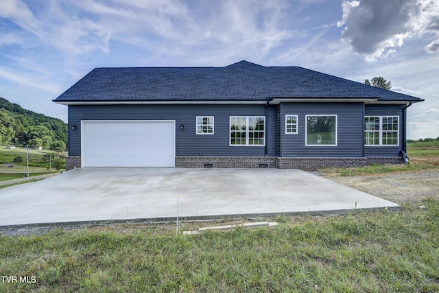 rear view of house with a garage