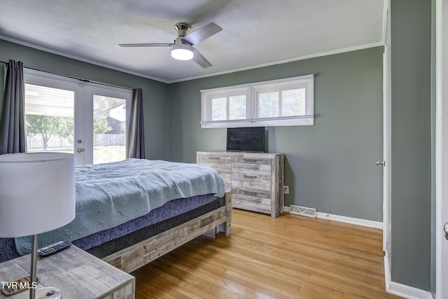 bedroom with french doors, access to outside, ceiling fan, crown molding, and wood-type flooring