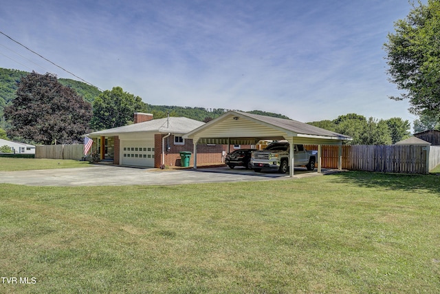 exterior space with a front lawn, a garage, and a carport