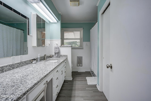 bathroom with heating unit, toilet, vanity, and hardwood / wood-style flooring