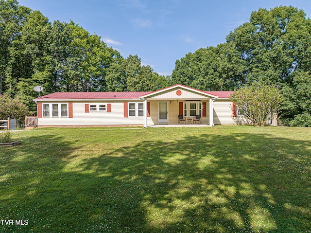 view of front of home with a front yard and a patio