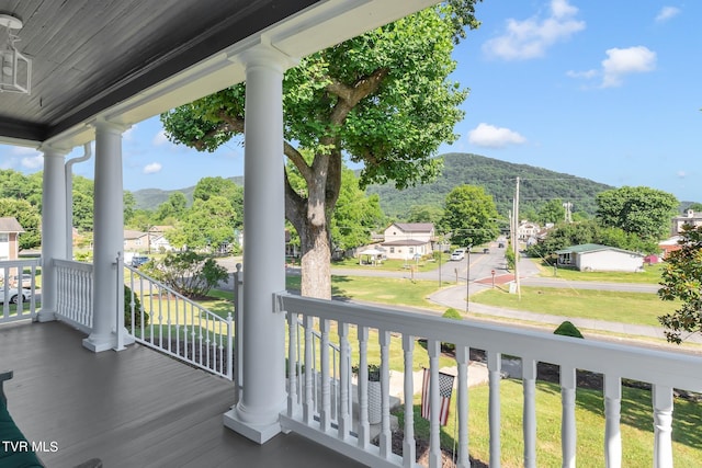 balcony with a mountain view and a porch