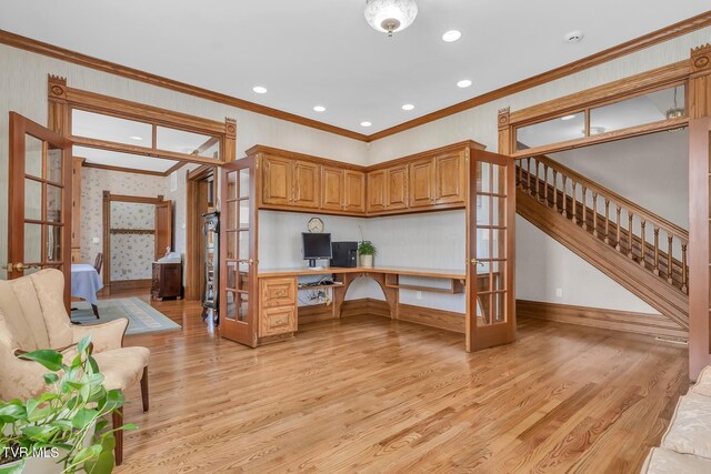 308 E Pearl Ave, Big Stone Gap, VA 24219 - kitchen featuring french doors, ornamental molding, light wood finished floors, built in desk, and brown cabinets
