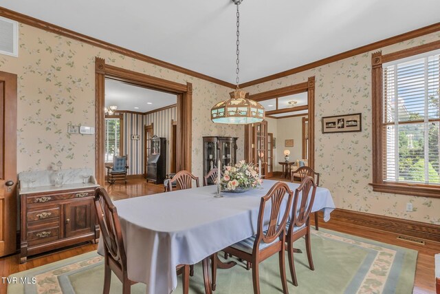 308 E Pearl Ave, Big Stone Gap, VA 24219 - dining area with wallpapered walls, wood finished floors, and ornamental molding