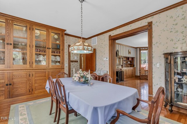 308 E Pearl Ave, Big Stone Gap, VA 24219 - dining space with wallpapered walls, wood finished floors, and ornamental molding