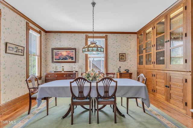 dining room with crown molding and wood-type flooring