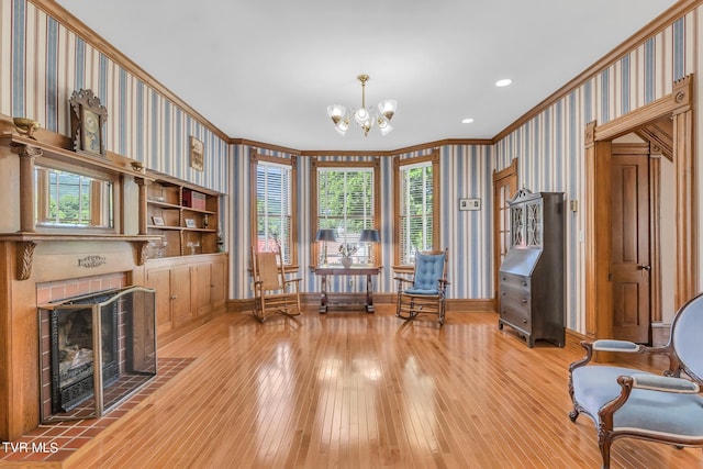 living area featuring a healthy amount of sunlight, light hardwood / wood-style floors, and a fireplace