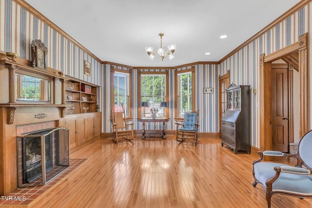 308 E Pearl Ave, Big Stone Gap, VA 24219 - living area with ornamental molding, wallpapered walls, hardwood / wood-style flooring, a chandelier, and a fireplace with flush hearth