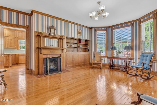 308 E Pearl Ave, Big Stone Gap, VA 24219 - living area featuring light wood-type flooring, crown molding, a tile fireplace, a chandelier, and wallpapered walls