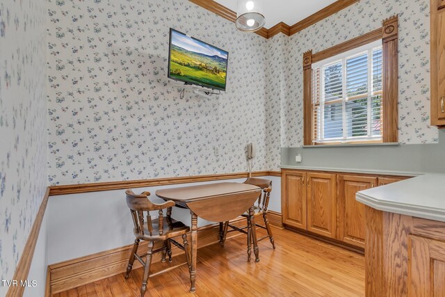 308 E Pearl Ave, Big Stone Gap, VA 24219 - dining room with wallpapered walls, crown molding, and light wood-type flooring