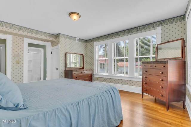 308 E Pearl Ave, Big Stone Gap, VA 24219 - bedroom featuring wallpapered walls and wood finished floors