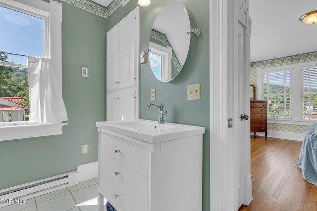 308 E Pearl Ave, Big Stone Gap, VA 24219 - bathroom with a baseboard heating unit, vanity, and wood finished floors