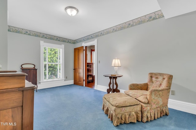 living area featuring dark carpet