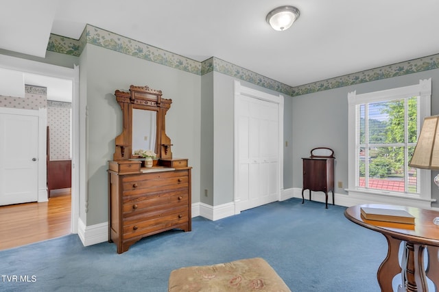 sitting room featuring dark carpet