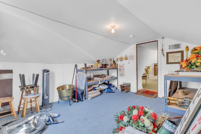 rec room featuring carpet flooring and vaulted ceiling