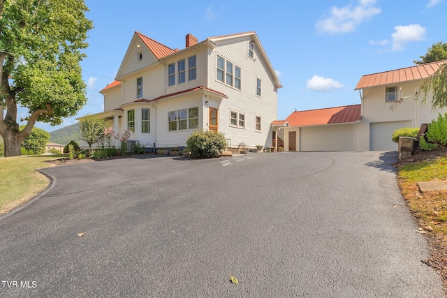 view of front of house with a garage and an outdoor structure