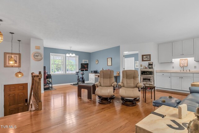 308 E Pearl Ave, Big Stone Gap, VA 24219 - living room with light wood finished floors and a chandelier