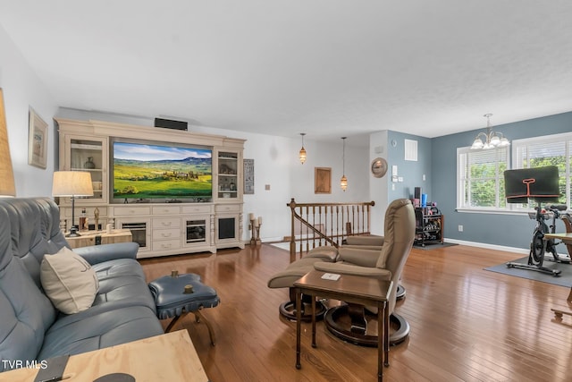 living room featuring a notable chandelier and hardwood / wood-style flooring