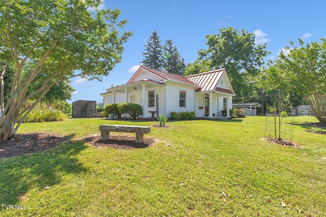 308 E Pearl Ave, Big Stone Gap, VA 24219 - rear view of property with a lawn, a standing seam roof, and a metal roof