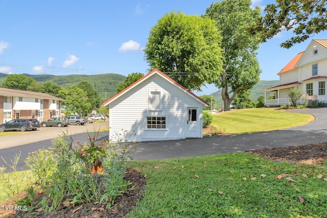 view of side of home with a lawn