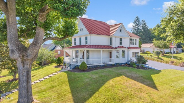 308 E Pearl Ave, Big Stone Gap, VA 24219 - view of front of house featuring covered porch, a metal roof, a front yard, and a standing seam roof