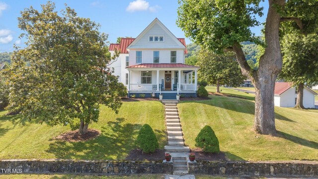 308 E Pearl Ave, Big Stone Gap, VA 24219 - view of front of home with a porch, a front lawn, and a standing seam roof