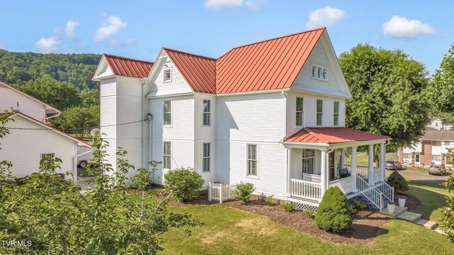308 E Pearl Ave, Big Stone Gap, VA 24219 - view of front of home with covered porch, a metal roof, a standing seam roof, and a front lawn