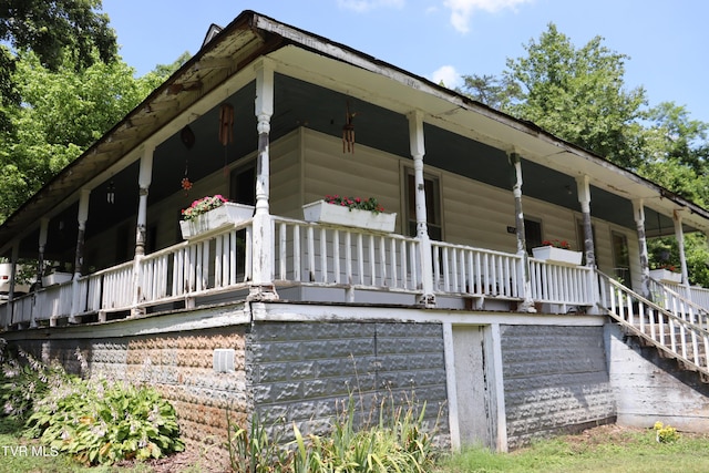 view of side of property with a porch