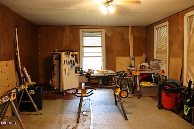 miscellaneous room with a workshop area and wooden walls